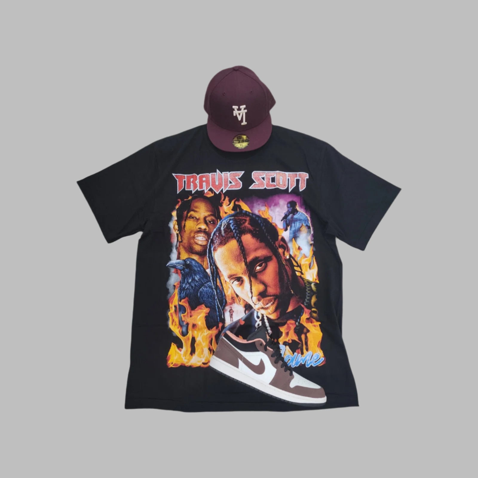 Black t-shirt with graphic design and maroon cap on gray background